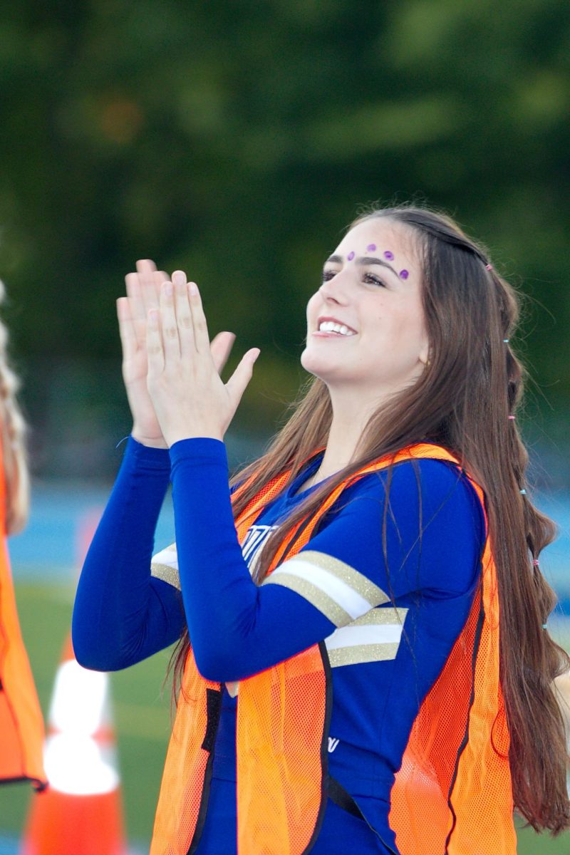 Gianna Leffel gets the Homecoming student section warmed up with cheers.