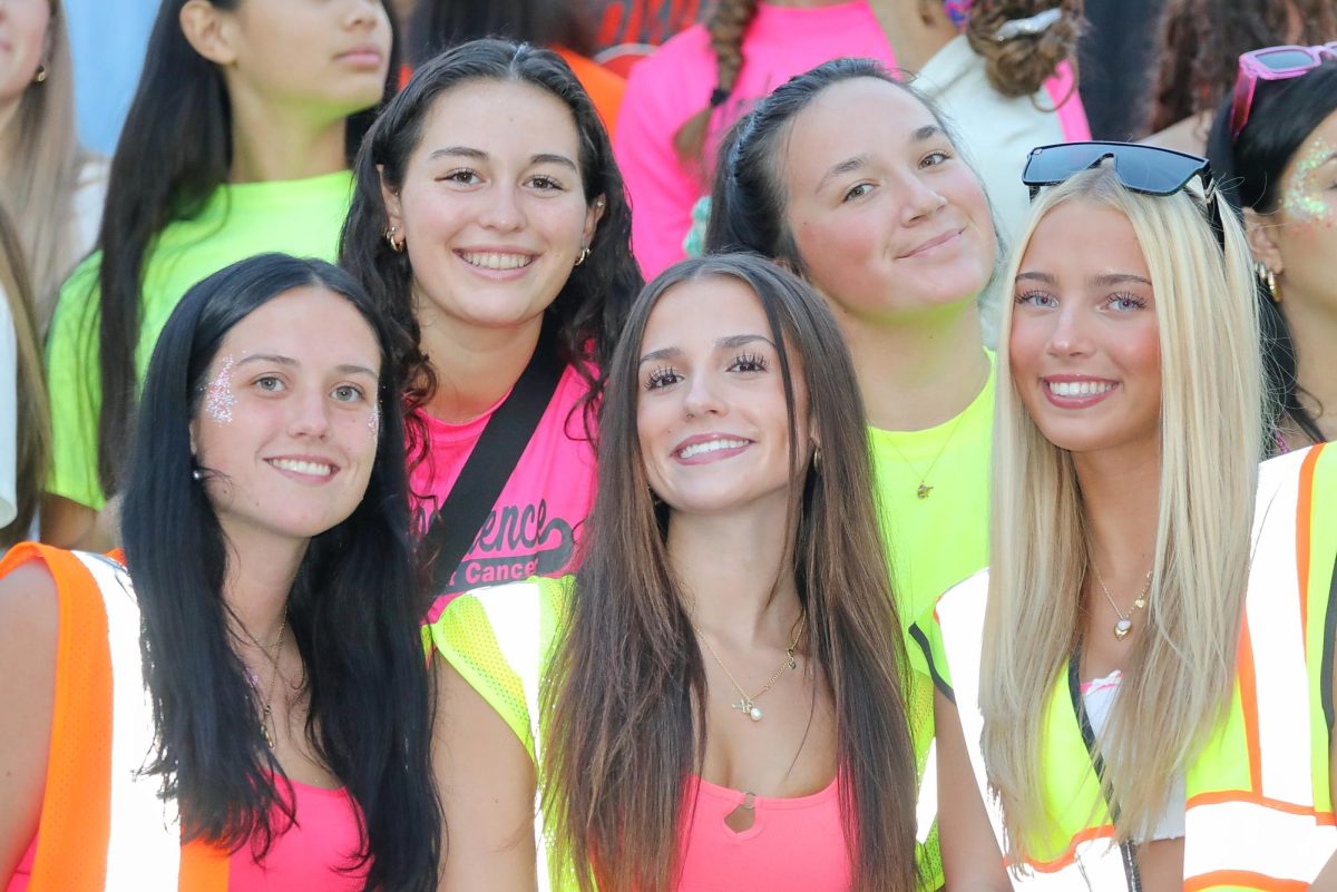 Becca Gibson, Megan Washington (back row) and Allie Bohrer, Brooke Balser and Brooke Patton (front row) in neon at the Homecoming game.