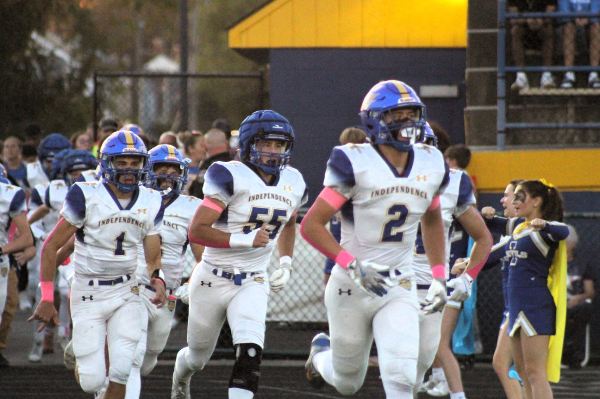 Senior football captains #2 Liam Rienerth,  #55 Alex Waski, #1 Stephen Mlynarczyk running out before the game