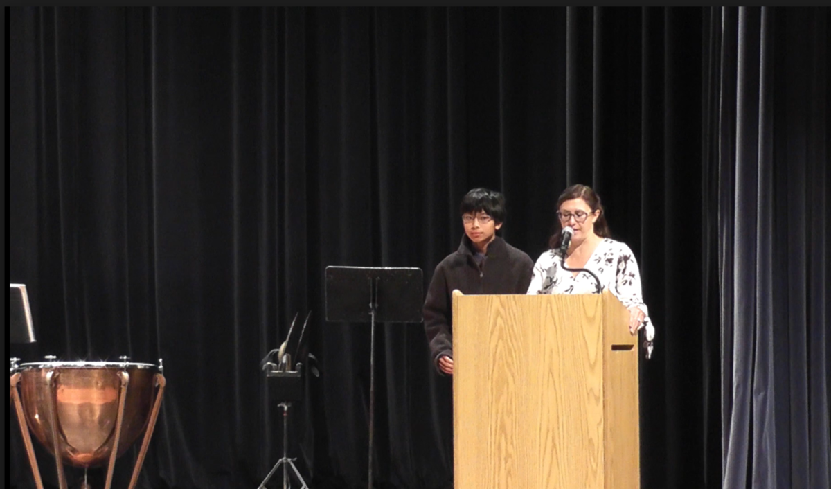 Eighth grade teacher Mrs. Josephine Vecchio introduces the speaker Jayden Musni.