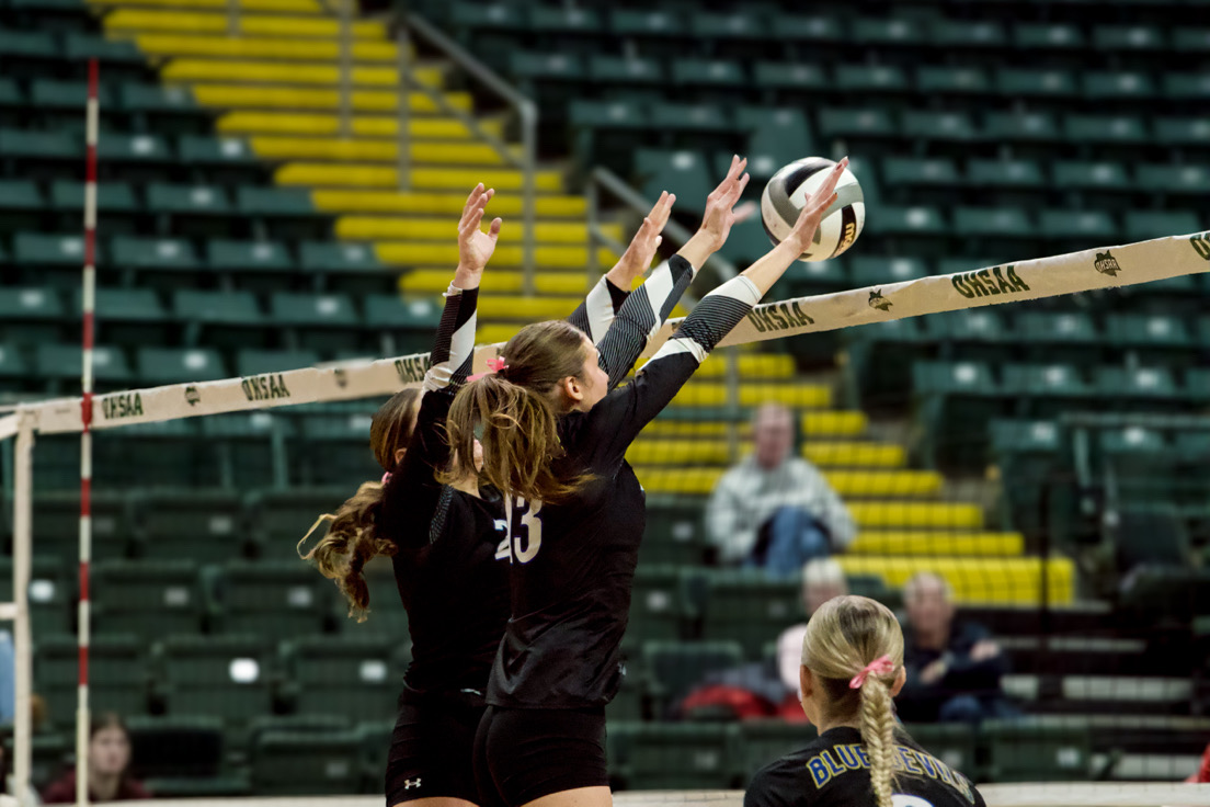 Senior #13 Giada Spisak blocking the ball at the State Semi-Final against Saint Henry 