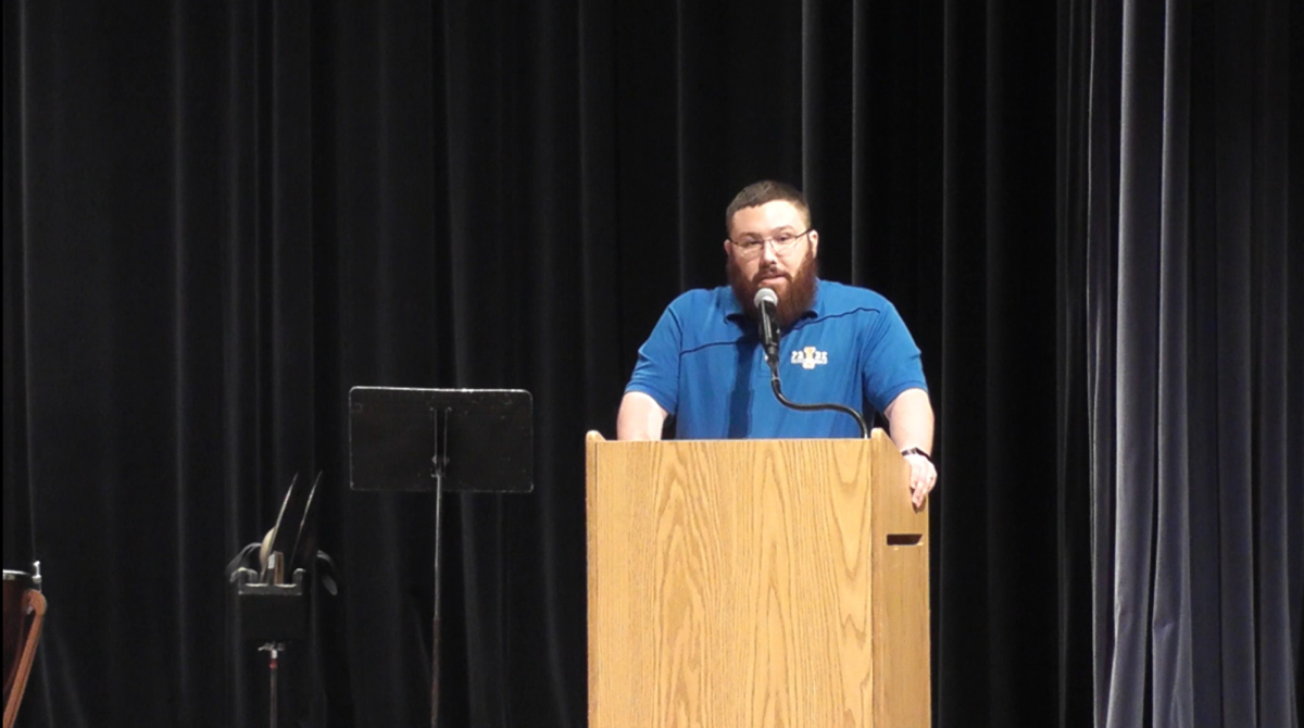 Mr. Michael Greene introduces the IHS and IMS choir.