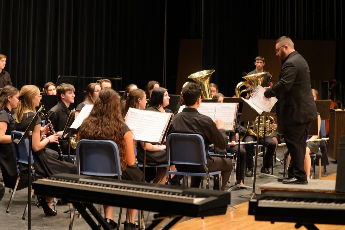 IHS Wind Ensemble waiting to preform their next song during the IHS winter concert.