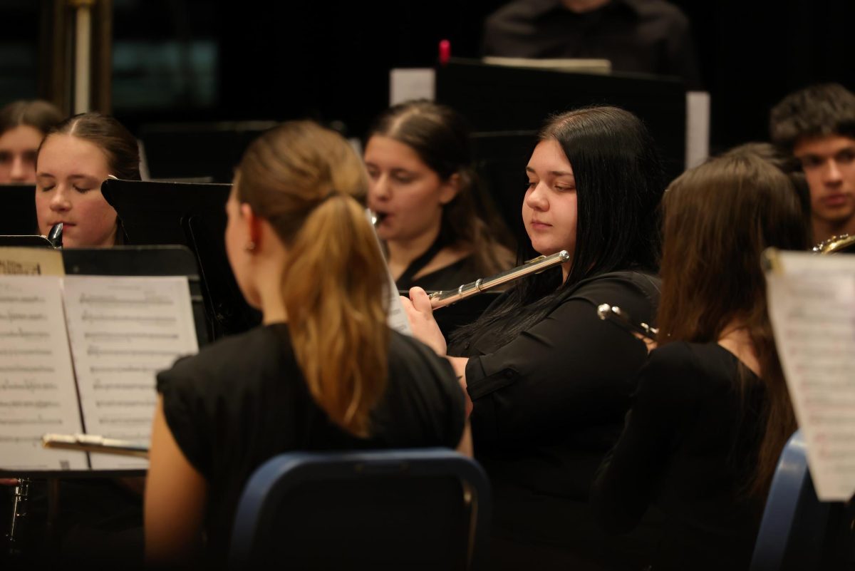 Senior Gracie Mindzora prepping for her solo during Son of Santa the Barbarian.