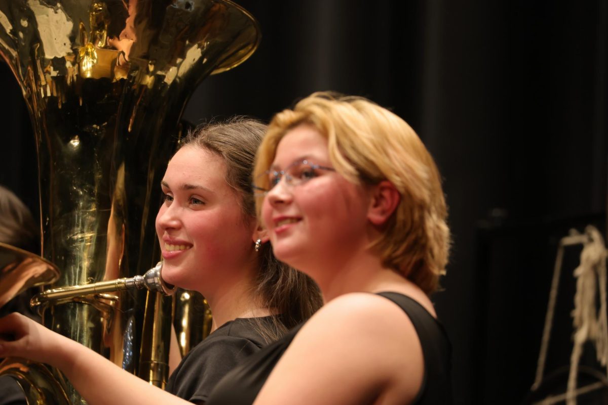Senior Tillie Averre and freshman Quincy Carlisle smiling for a picture after the band concert.