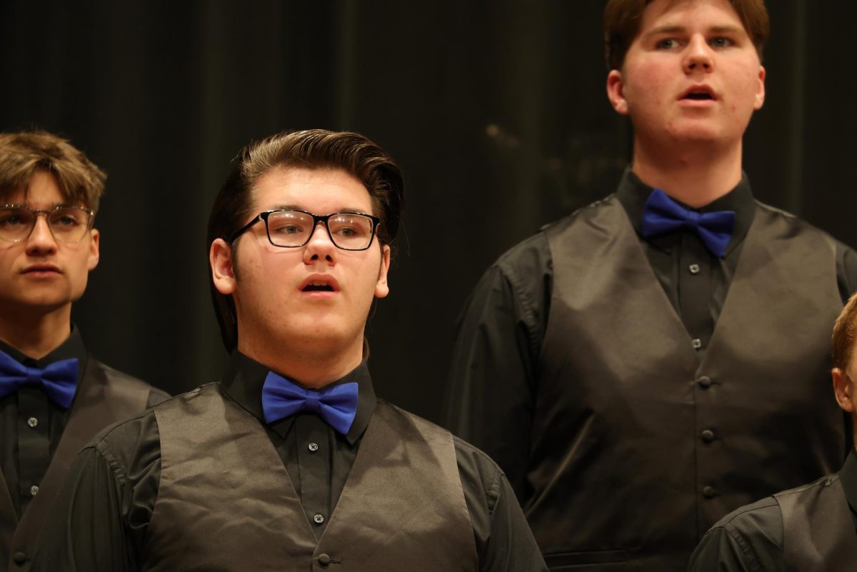 Junior Robby Kalman, sophomore Troy Snyder, and freshman Alexander Jaworske singing for the IHS Vocal Ensemble.