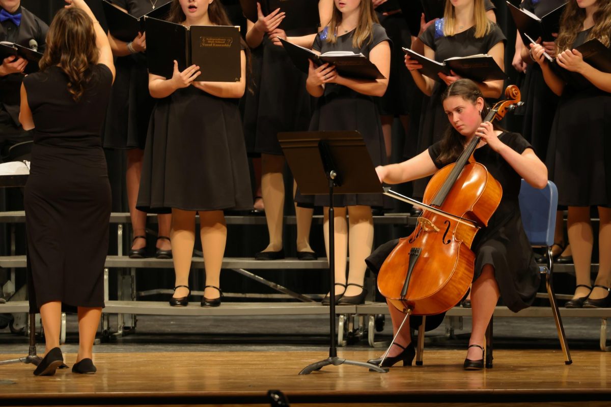 Senior Tillie Averre playing her cello for the IHS Vocal Ensemble.