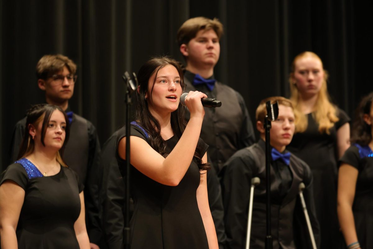 Senior Brooke Vollman singing her solo during 