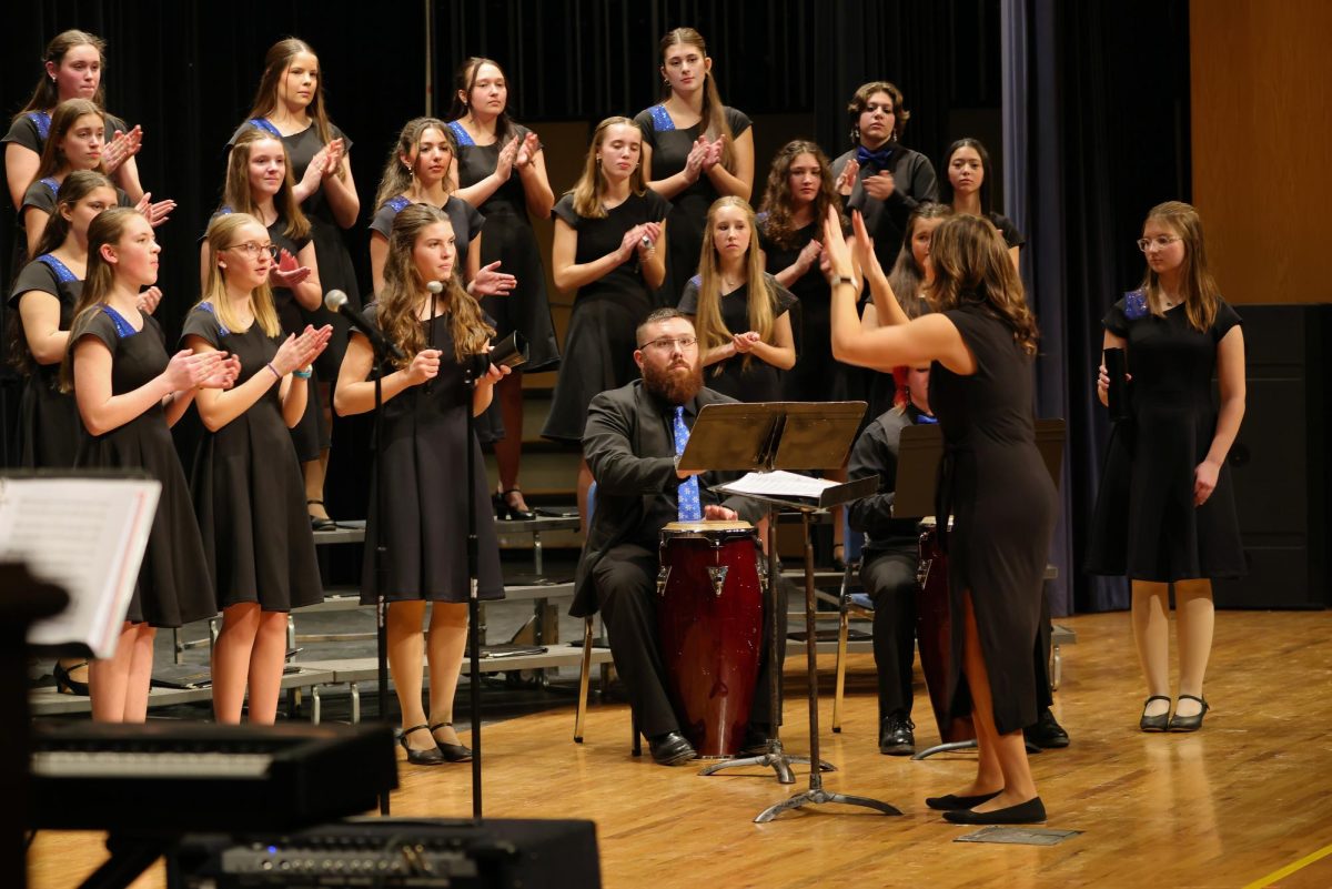 Mr. Micheal Greene playing the drum during the IHS Vocal Ensemble portion of the winter concert.