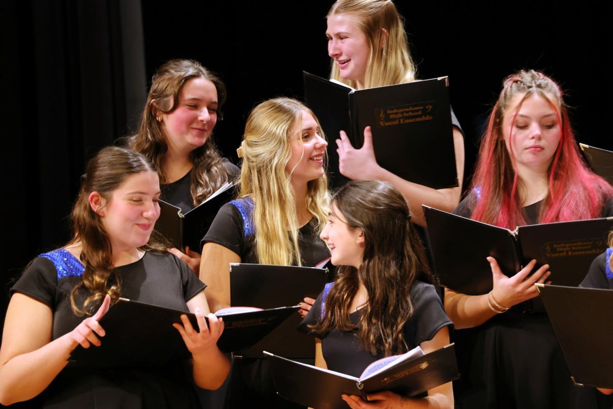 A group of students waiting patiently for the next song of the winter concert to start.