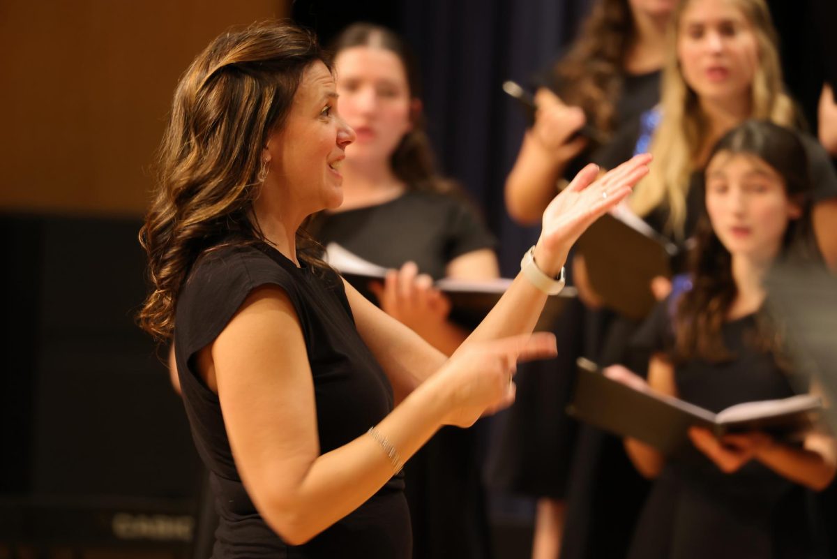 Vocal Ensemble director Mrs. Gretchen Obravac conducting for the students.