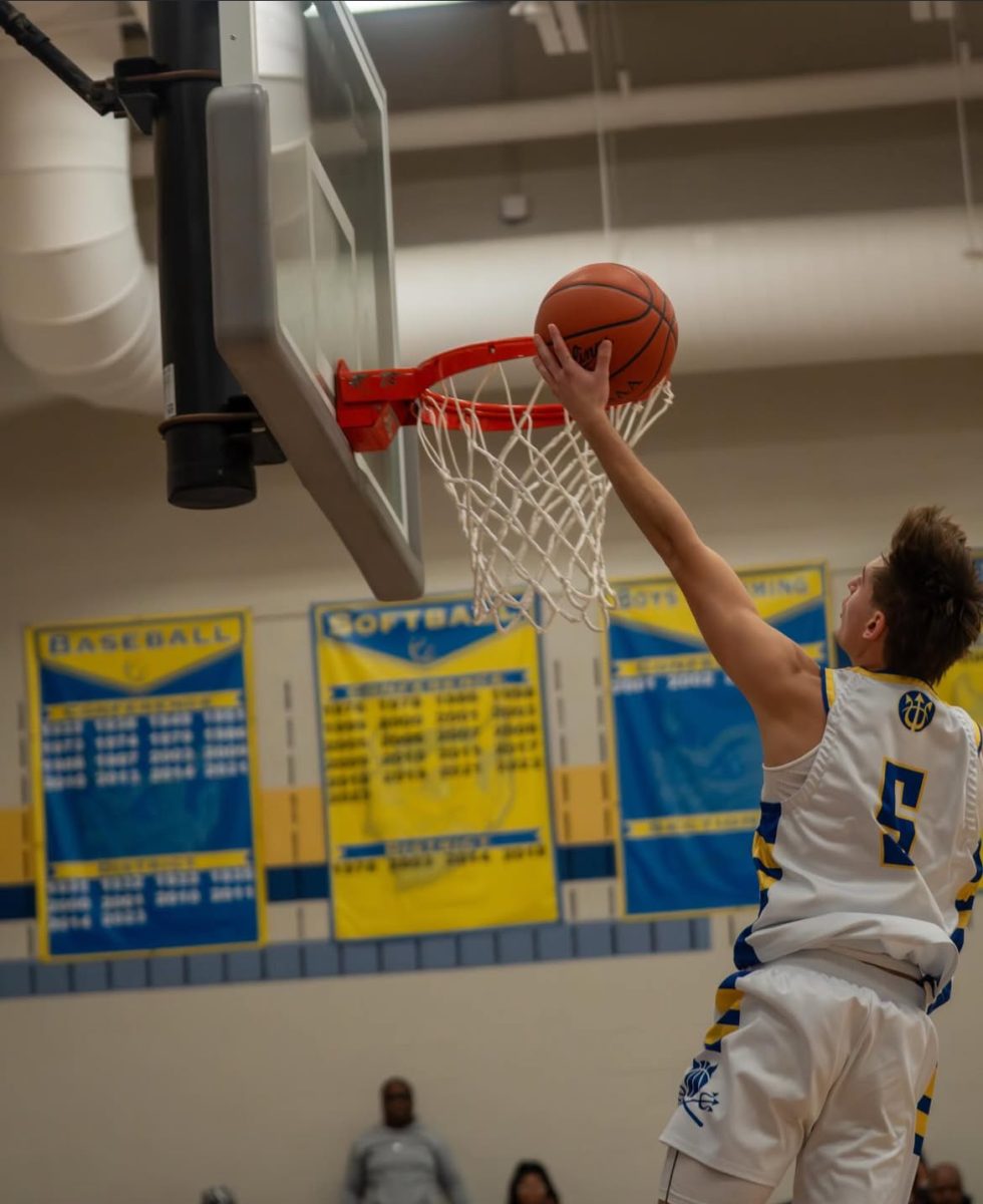 Senior Jakob Jurkiewicz shooting a left handed layup during the game against Trinity.