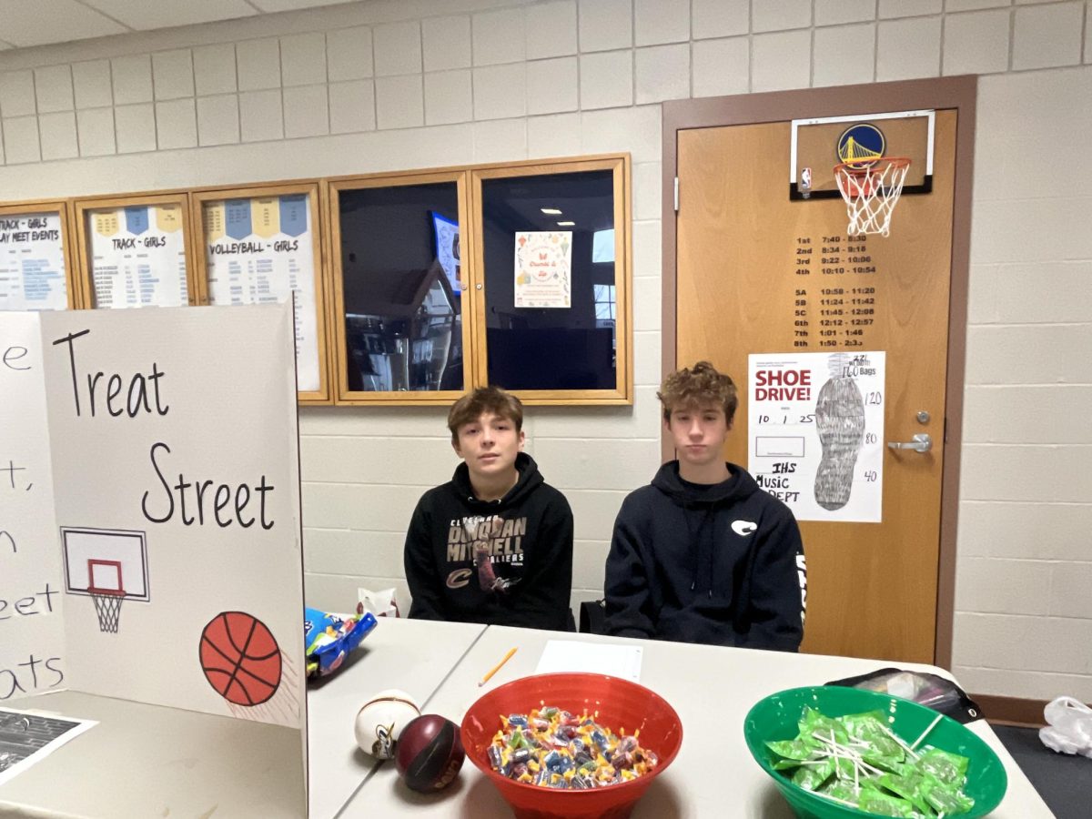 Sophomores Nick Spencer and Bryce Kwiatkowski posing with their freshly set up business "Treat Street" selling 