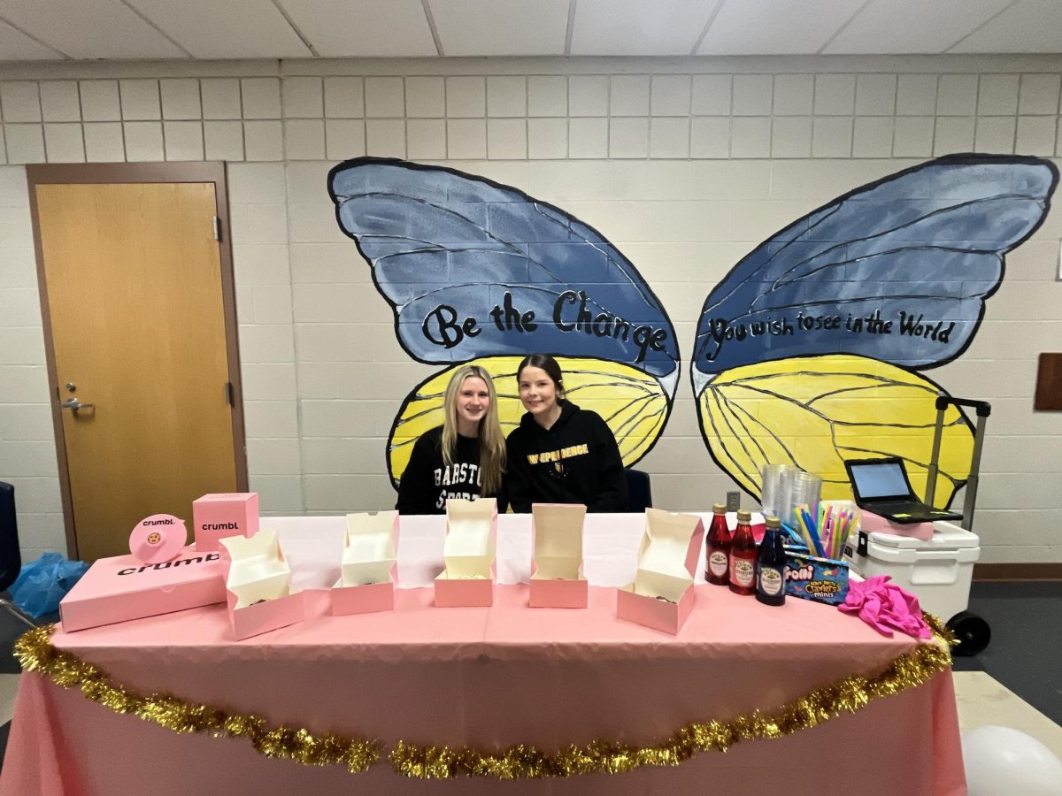 Sophomores Cassidy McKinley and Emily Slusher posing with their business before lunch starts.