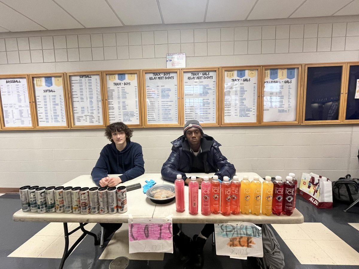 Sophomores Noah Shumay and Bobby Jackson posing with their business as they wait for lunch.