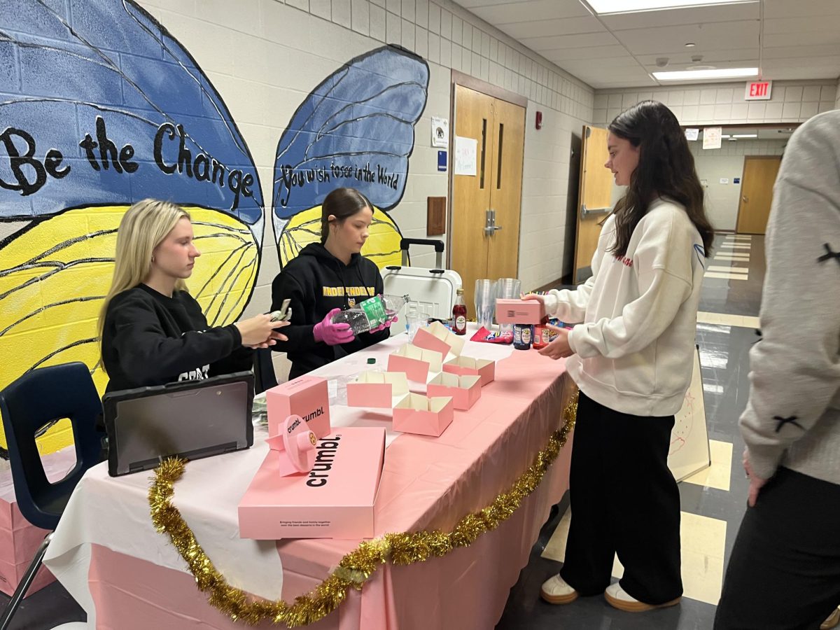 Sophomores Cassidy McKinley, and Emily Slusher selling their Crumbl Cookies during 5A lunch.