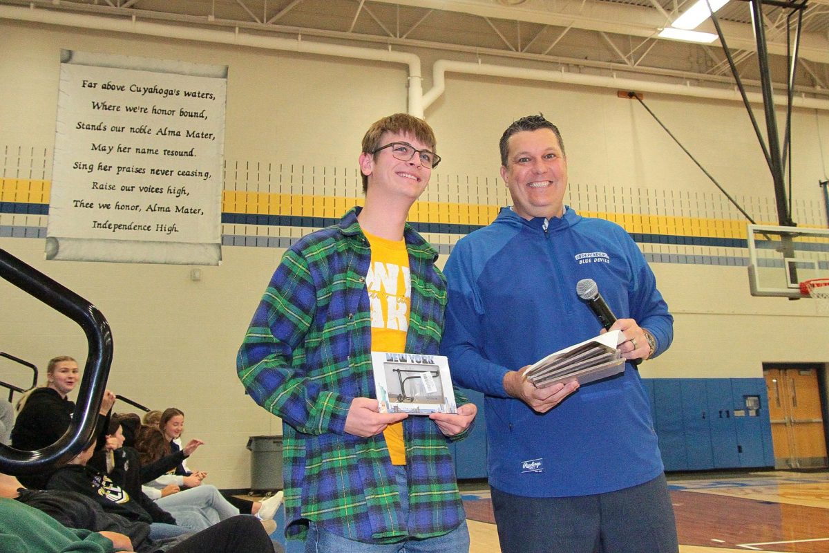 Mr. Janatovich presents senior Paul Kundmueller with the award for best "A moment that moved me" photo in The Spectator's NYC photo contest.