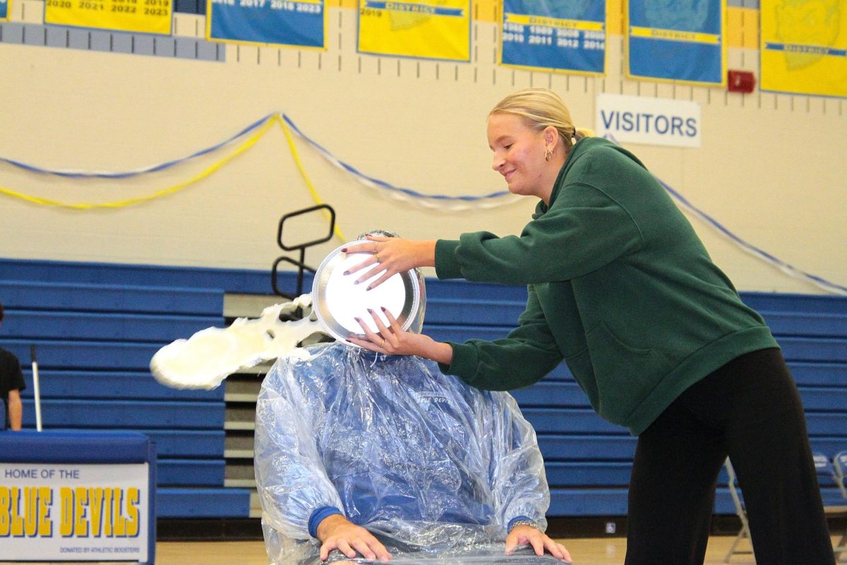 Mr. Mike Janatovich being pied by Senior Haley Wilson.