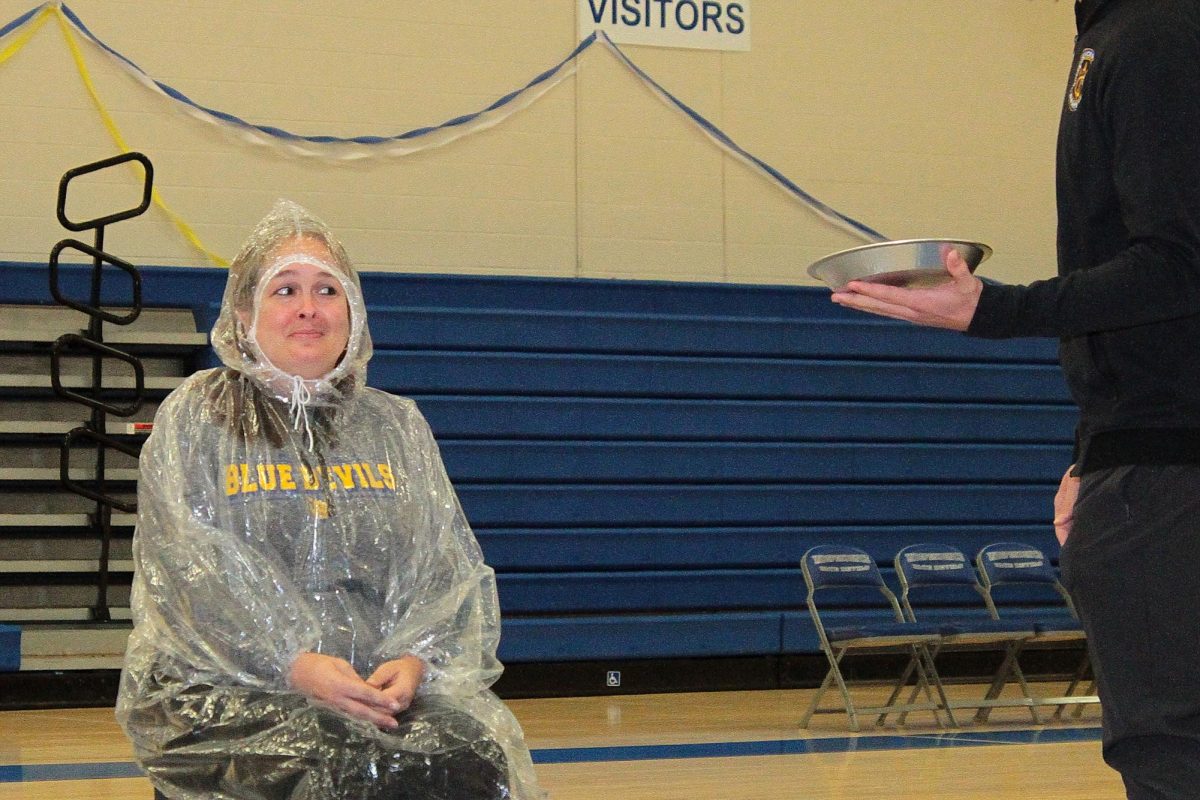 Mrs. Jennifer Lewis anxiously waiting getting pied by Senior Liam Reinerth.