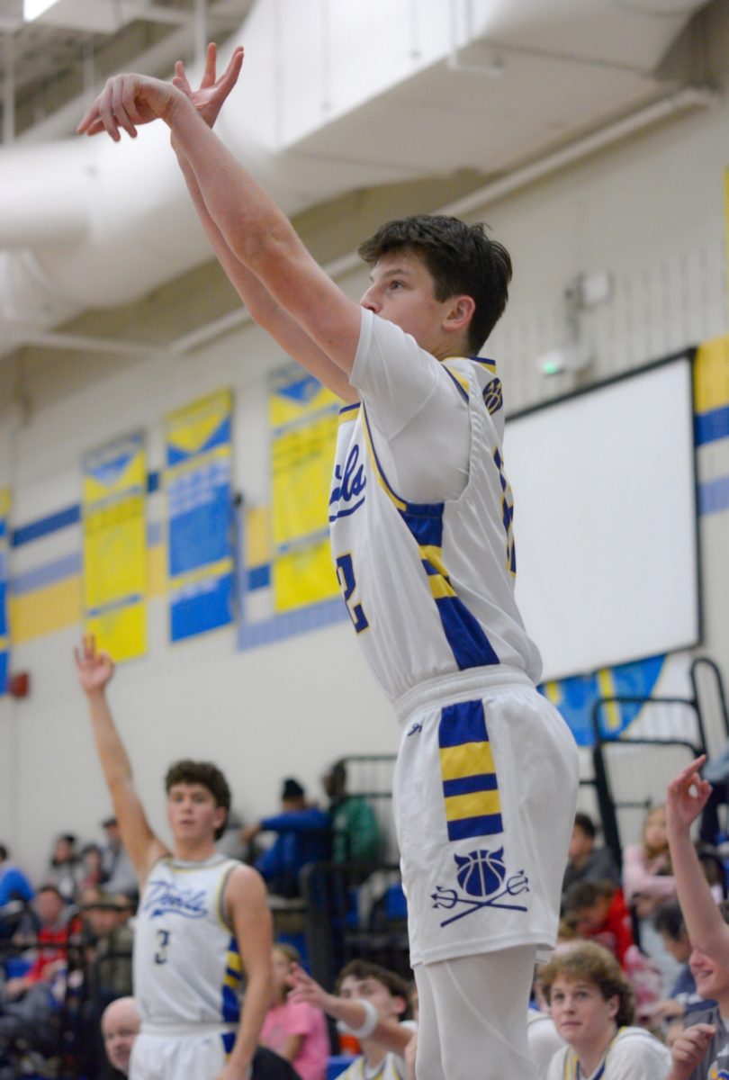 Junior 12 Ryan Suhy shooting a 3-pointer.