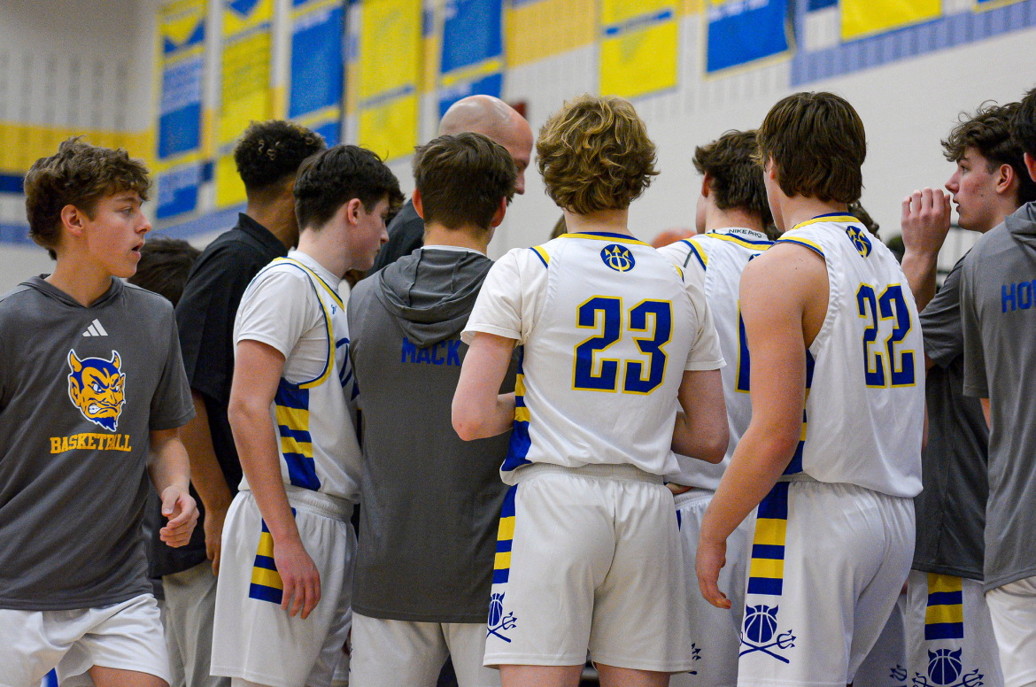 Boys Basketball huddled before the game against the Open Door Patriots.