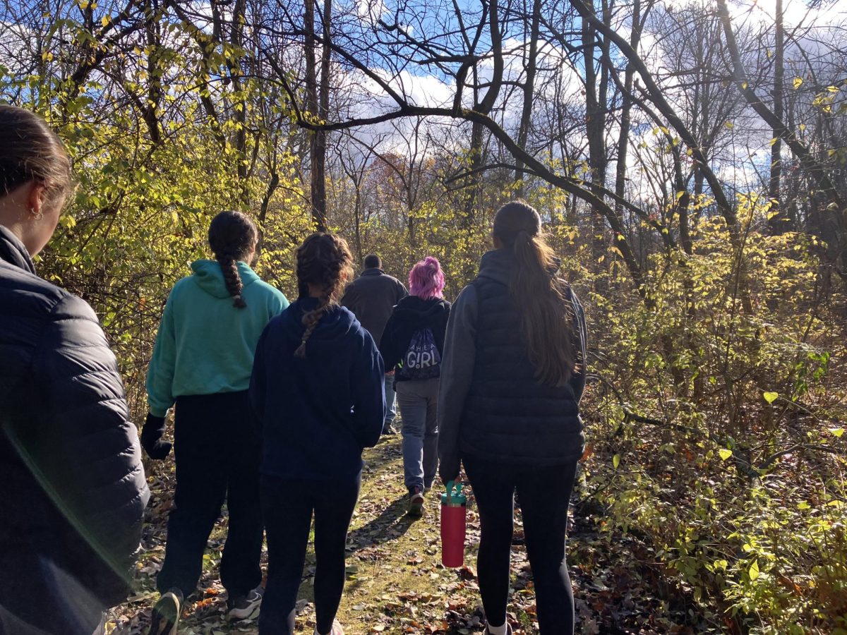 Mr. Maretka leads students through the trails of the Land Lab.