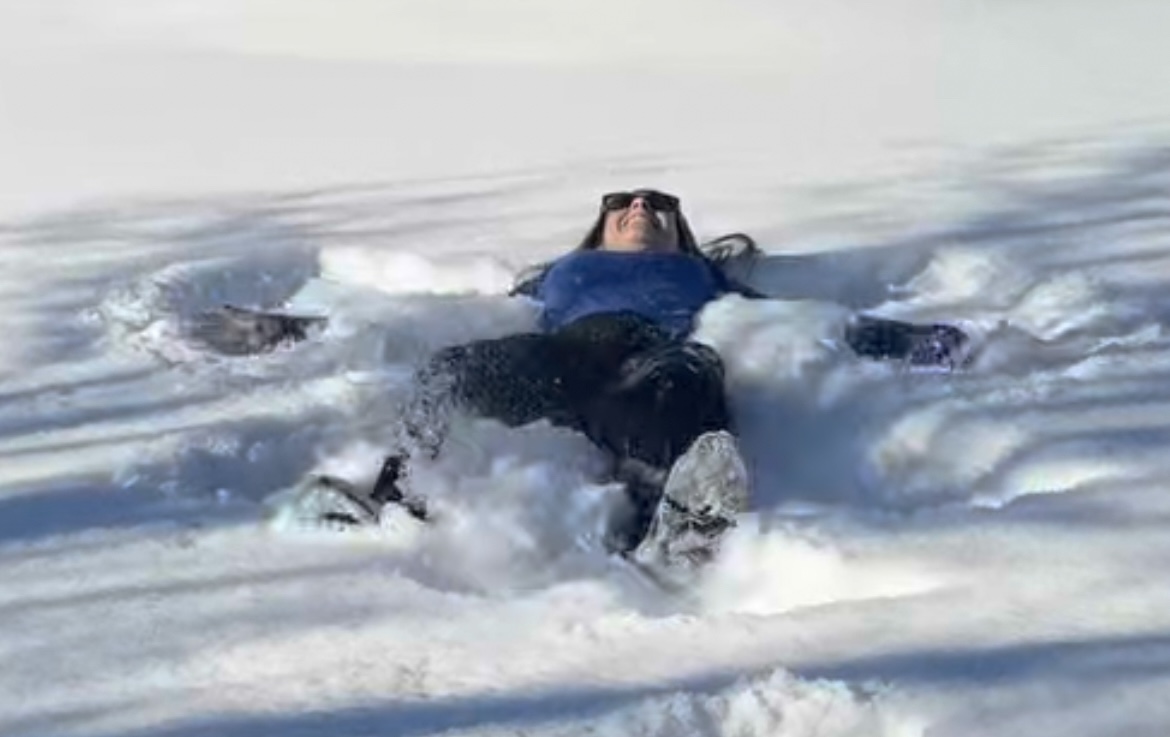 ILS School Board President Mrs. Katie Hill making a snow angel in her front yard