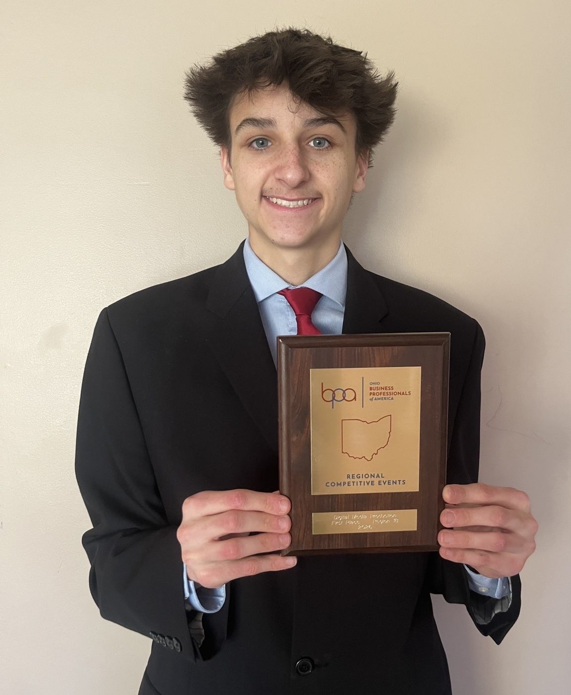 Xavier Shumay holds his first-place plaque for Digital Media Production.