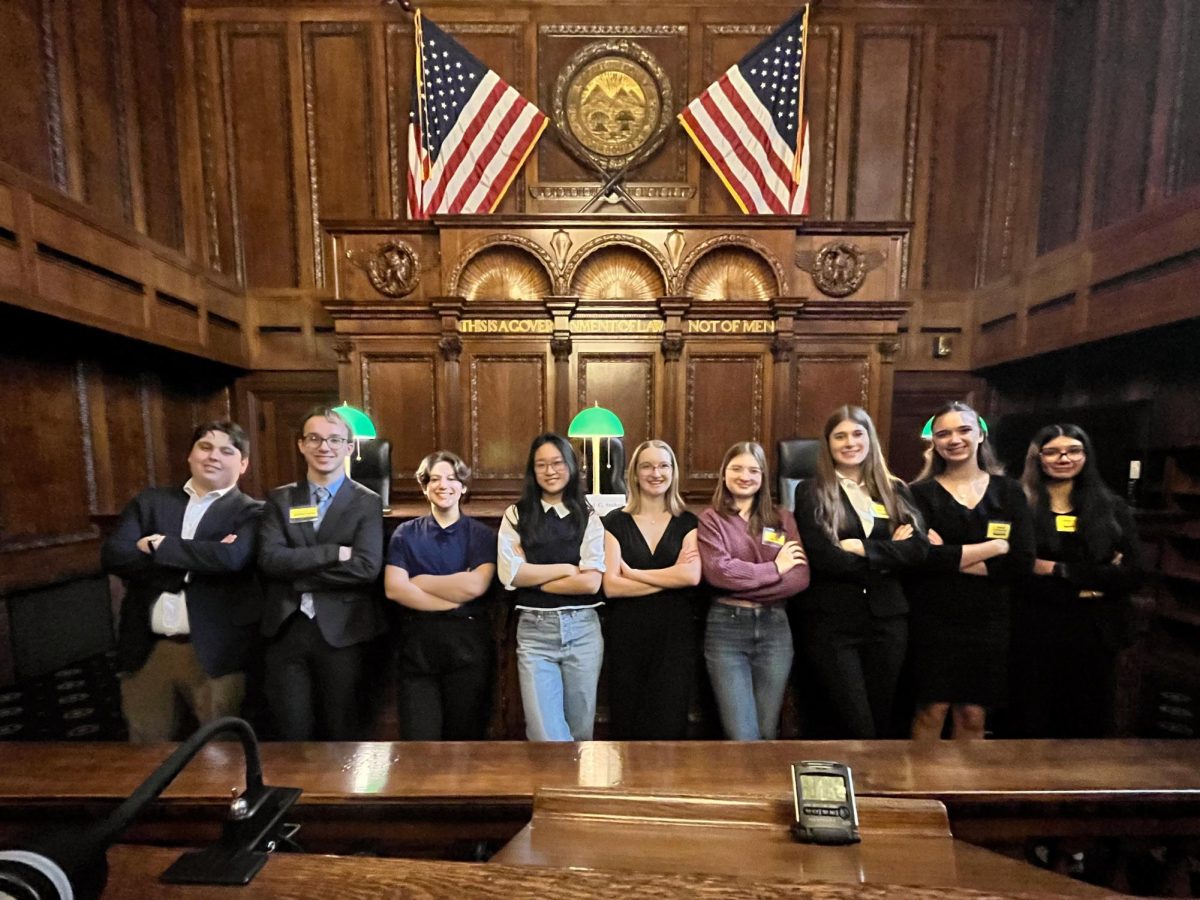 IHS Mock Trial team poses in the courtroom at the regional tournament.
L to R: Gio Hasrouni, Matthew Liepert, Vinny Carmean, Carmen Chen, Rylee Shepard, Jules Cherny, Maya Toth, Adriana Randjelovic, Sehaj Rai