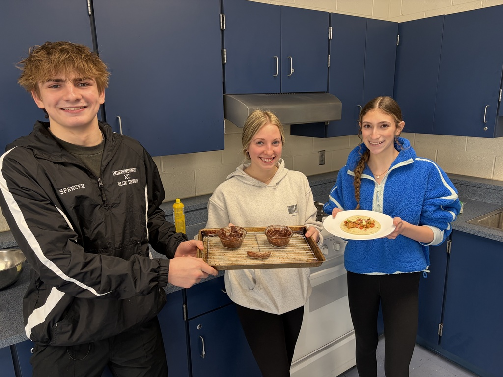 Sophomores Nicholas Spencer, Peyton Bechlem, and Tess Rienerth showing off a dish made in the Iron Chef class.