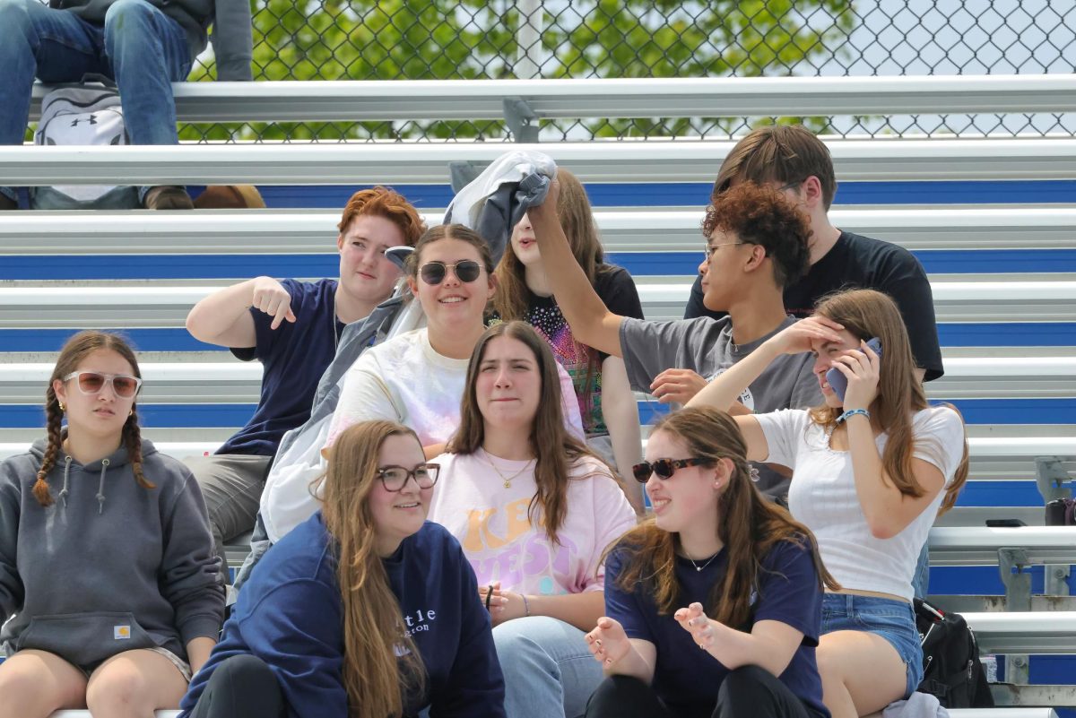 Juniors and seniors enjoy the sunshine while watching the kickball game on seniors' last day of classes. 