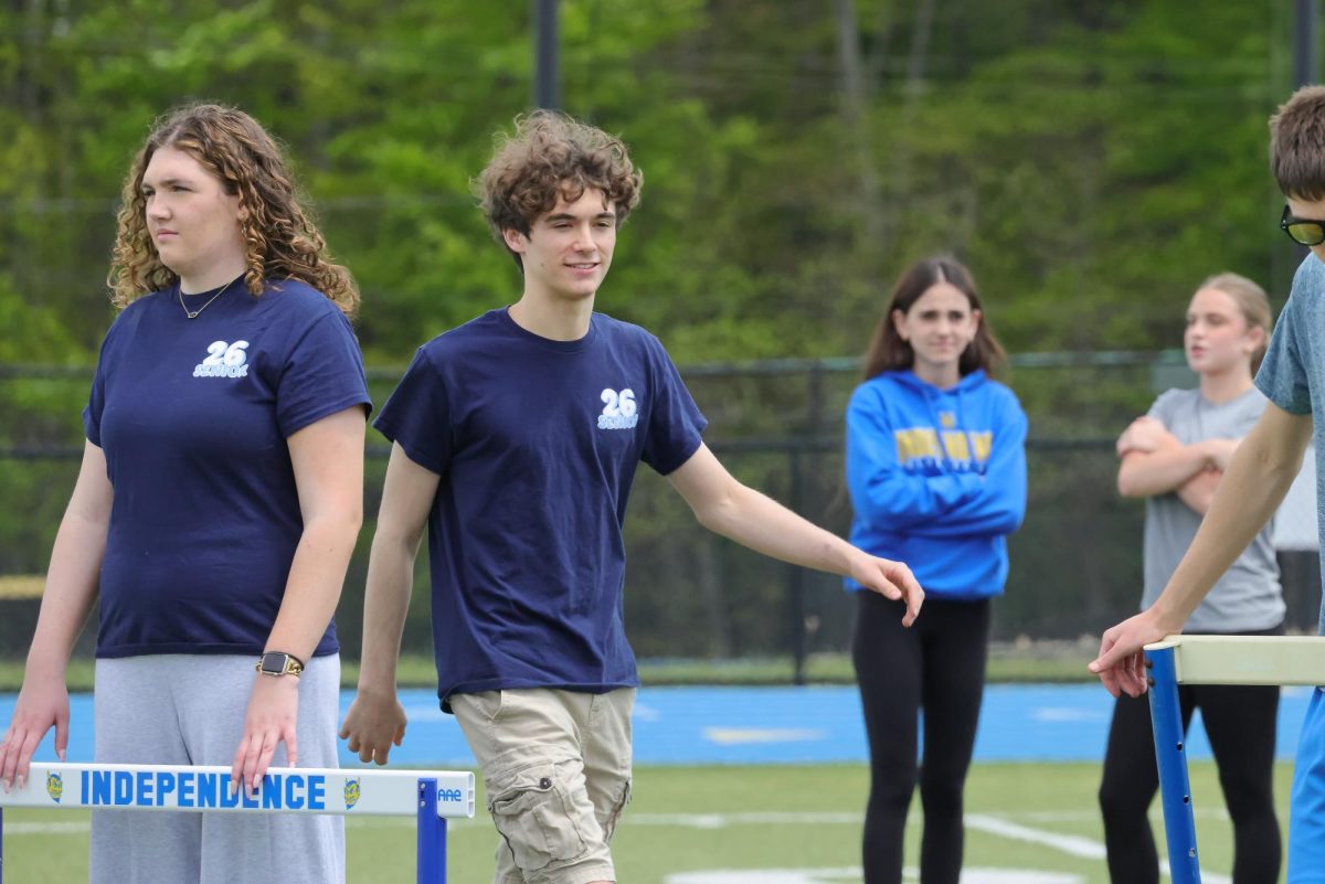 Seniors Lauren Dalrymple and Matthew Shamblen playing outfield during the kickball game on seniors' last day of classes.