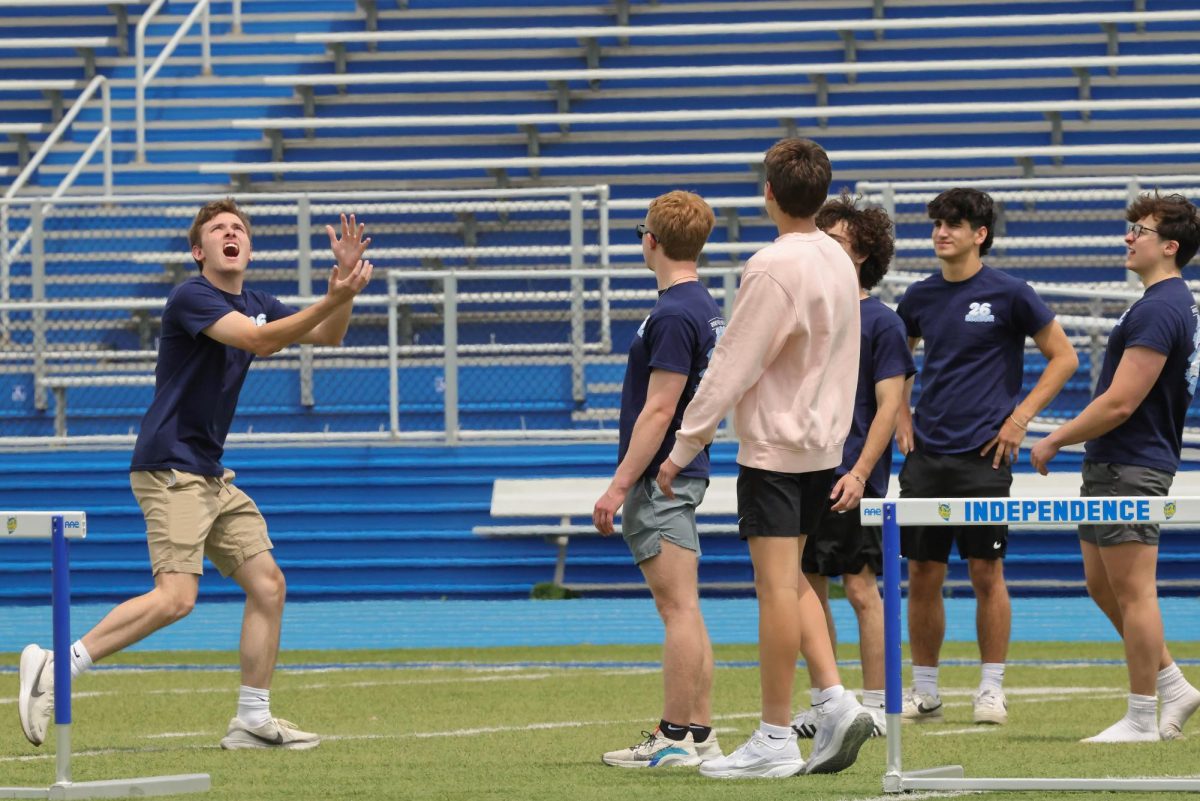 Teammates watch as Joe Fricano moves in for a big play.