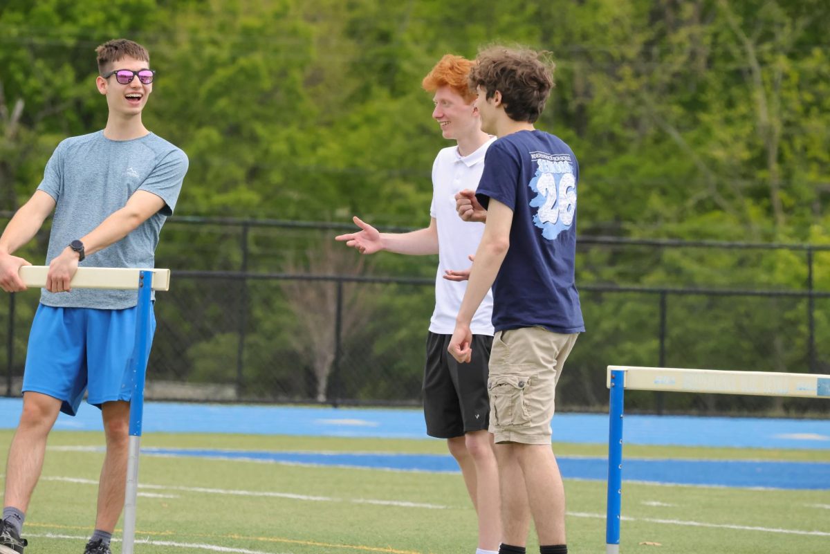 Seniors Tate McGovern, Grady Wachs and Matthew Shamblen enjoying time together on the field during the kickball game on seniors' last day.