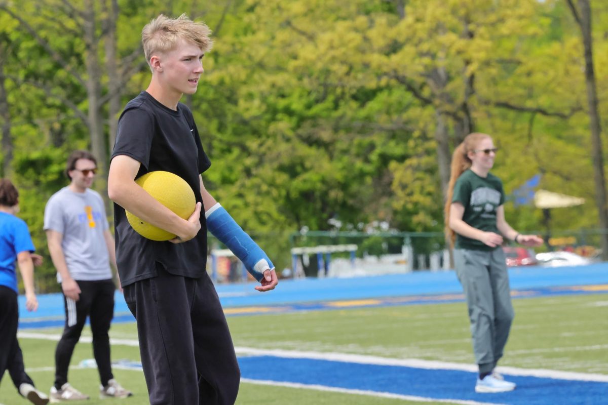 Junior David Crooks leads the juniors against the seniors at the kickball game on the last day of school for seniors.
