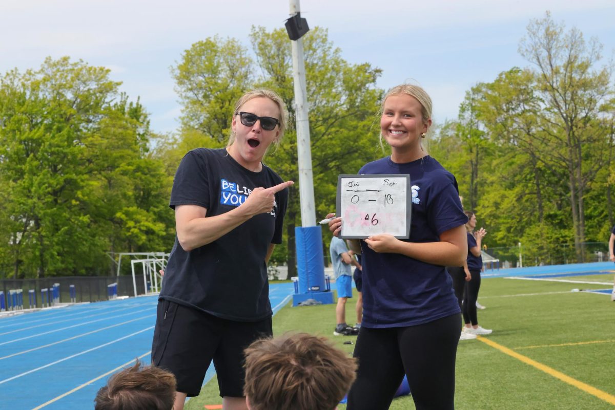 Mrs. Jessica Crooks reacts to the kickball game score presented by senior Maddie Mudra. 