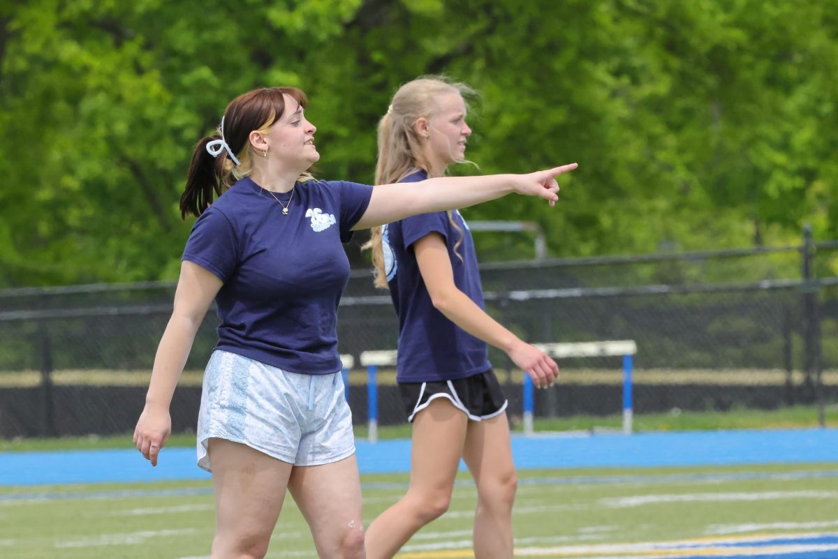 Seniors Maddie Kerns and MaryAnne LeRoy on the field at the kickball game.