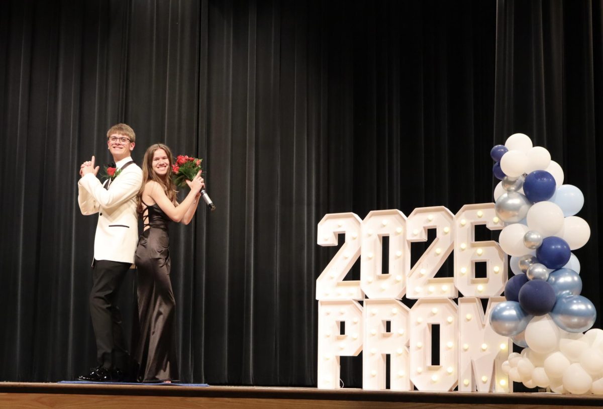 Samantha Kandzer '26 escorted by Paul Kundmueller '26 down the Blue Carpet 