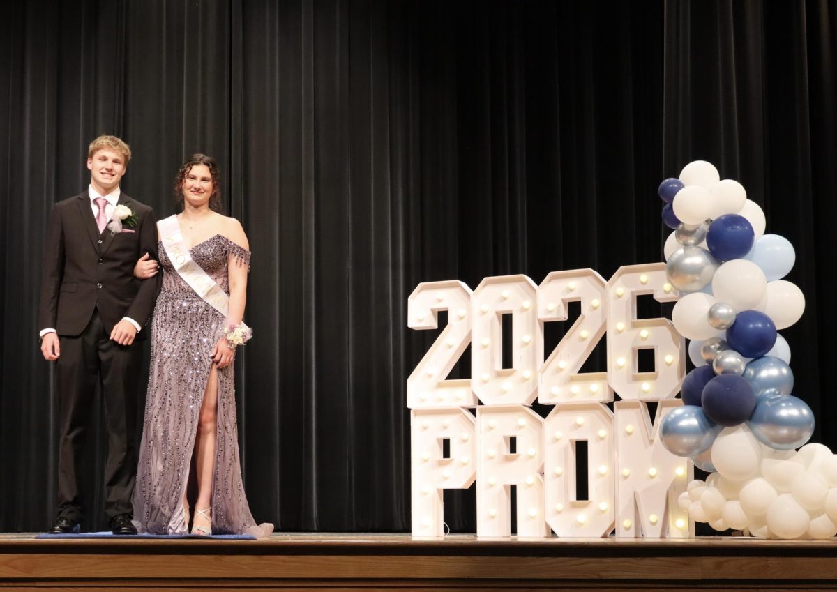 Nora Olexa '26 escorted by Jacob Repicky '28 down the Blue Carpet 