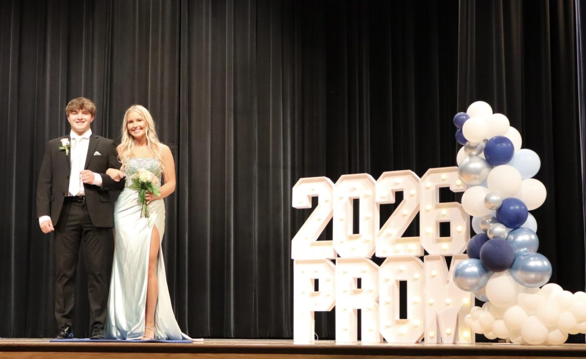 Madelyn Mudra '26 escorted by Dominic Narduzzi '25 down the Blue Carpet 