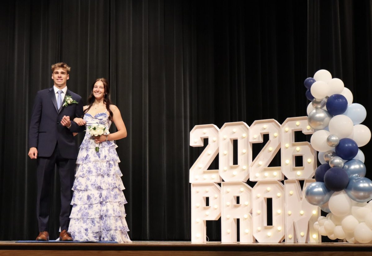 Brooke Vollman '26 escorted by Stephen Mlynarczyk '26 down the Blue Carpet 