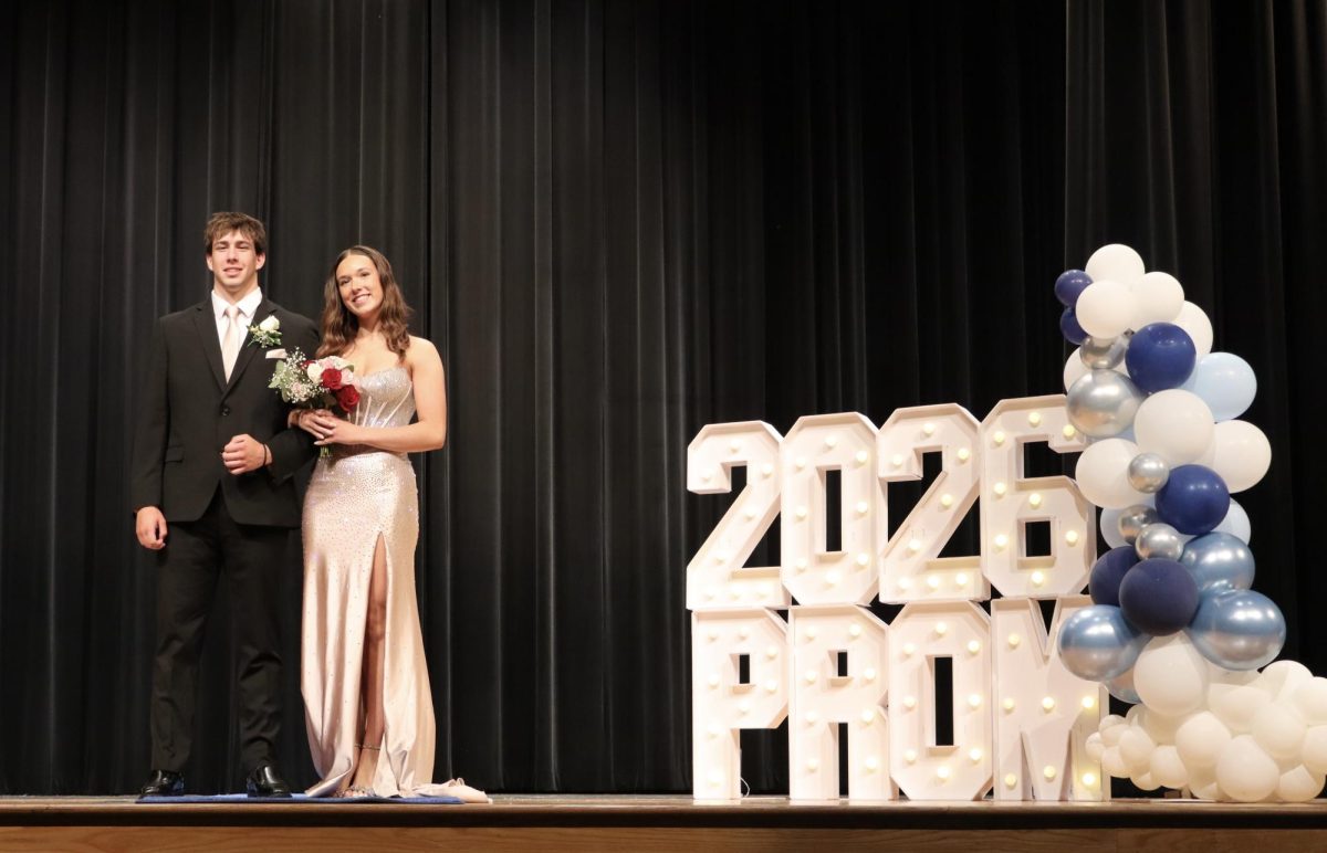Emily Gibbons '26 escorted by Alex Waski '26 down the Blue Carpet 