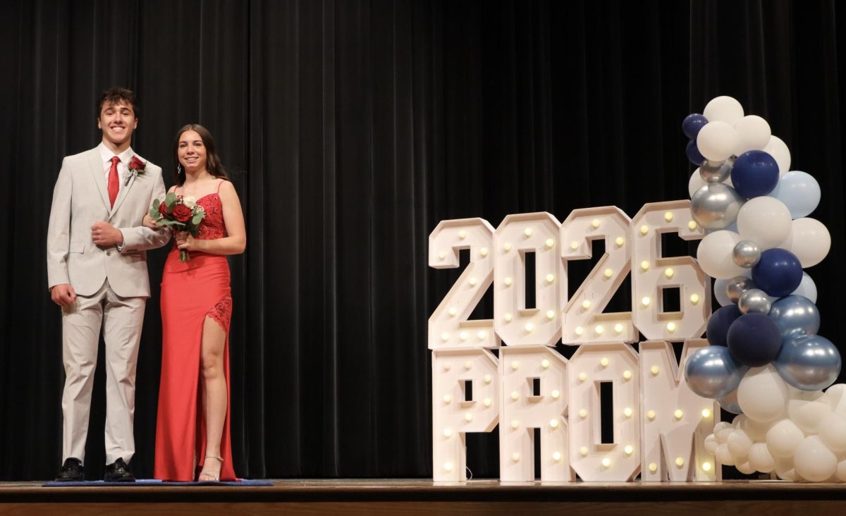 Gianna Carlucci '26 escorted by Shane Korinek '27 down the Blue Carpet 