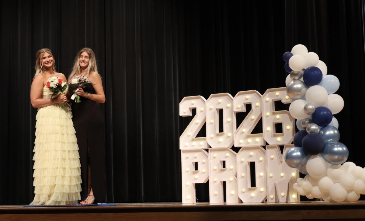 Lucy Spencer '26 and date walking down the Blue Carpet 