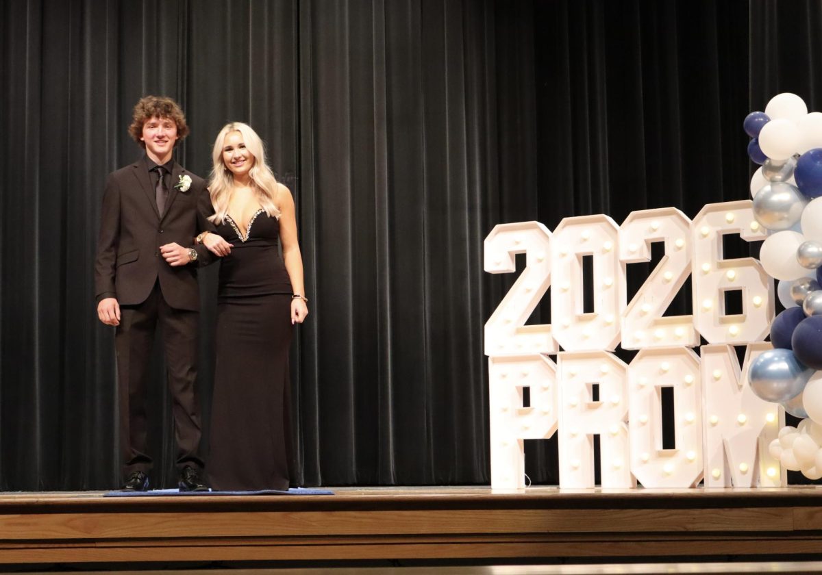 Katelyn Deblock '27 escorted by Joshua Gray '27 down the Blue Carpet 