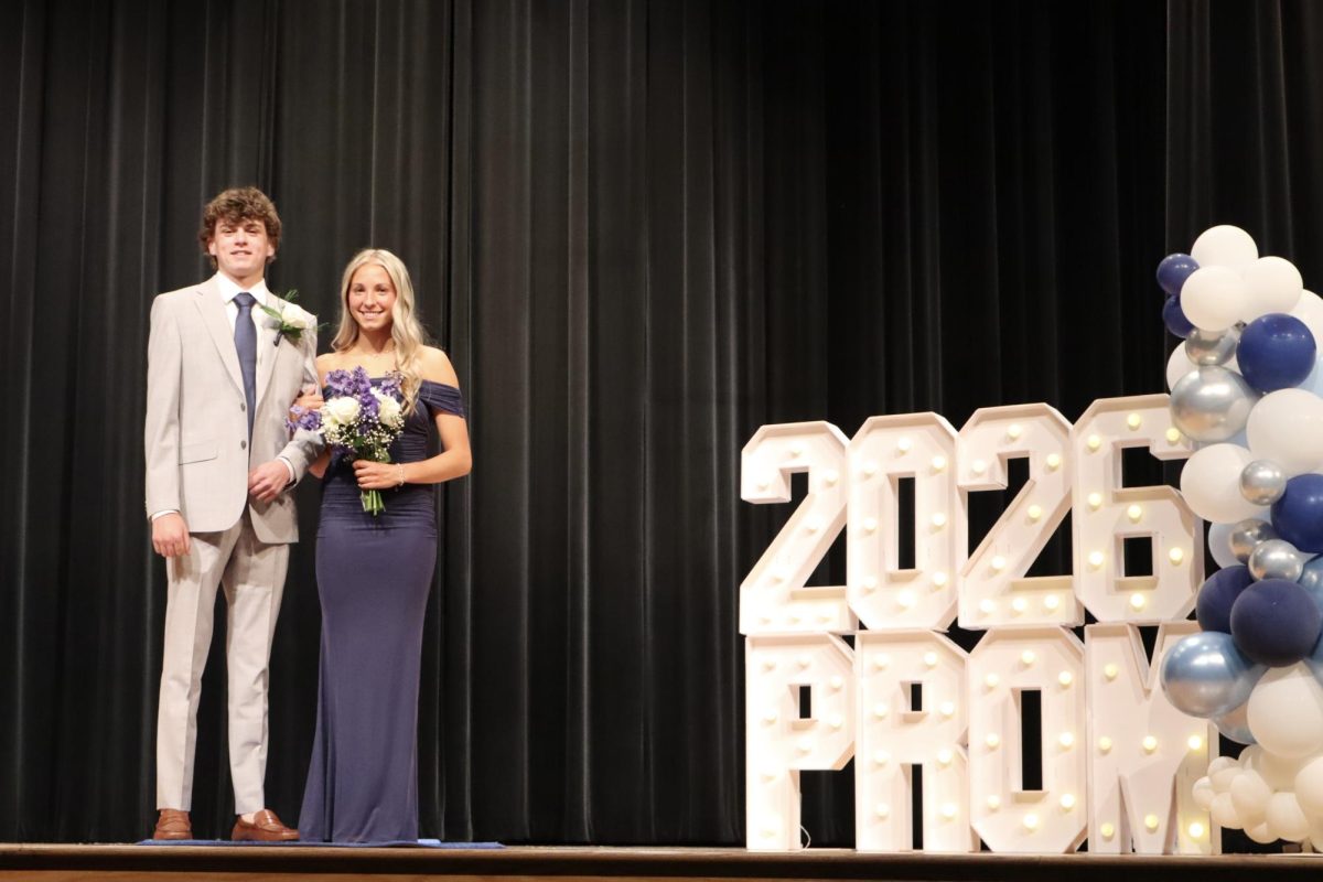 Peyton Bechlem '28 escorted by Kaden Schuette '27 down the Blue Carpet 