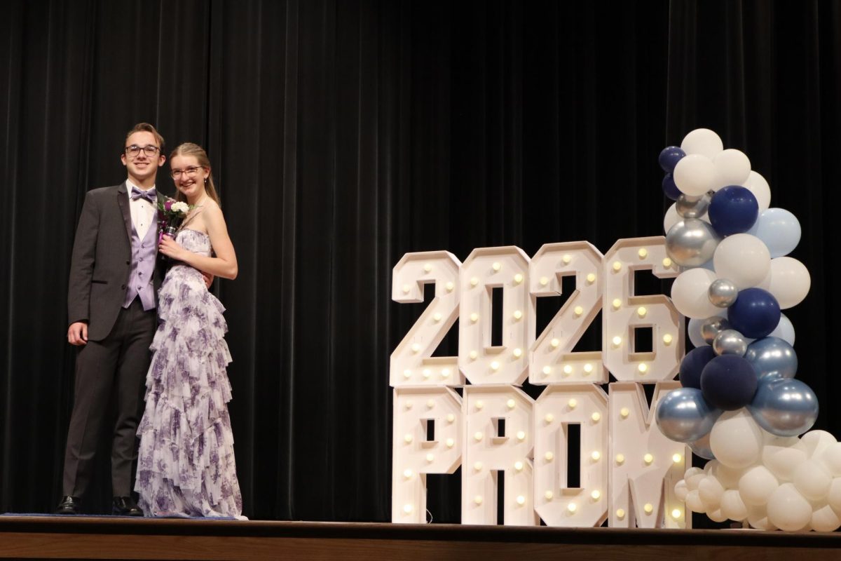 Rylee Shepard '27 escorted by Matthew Liepert '27 down the Blue Carpet 