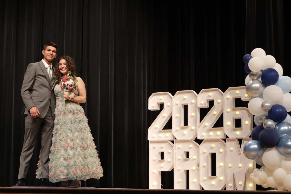Sophie Polter '27 escorted by William Stray '27 down the Blue Carpet 