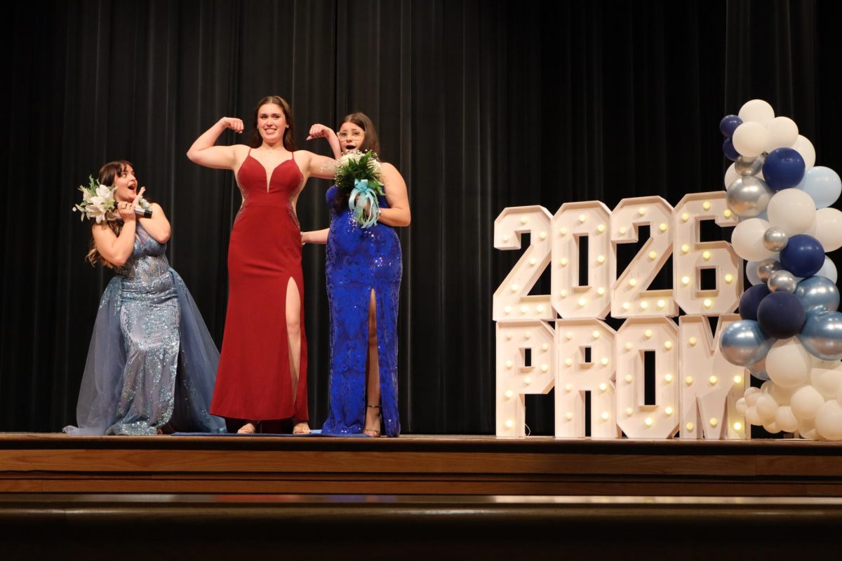 Madison Kerns '26, Tillie Averre '26, and Adeline Savage '28 walking down the Blue Carpet 
