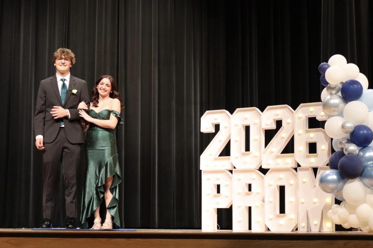Alyssa Carriero '27 escorted by Joshua Peters '26 down the Blue Carpet 